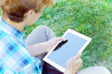 Young man is using tablet