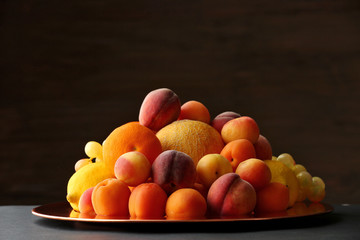 Heap of fresh fruits on dark background