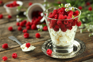 Healthy breakfast: fresh cheese with raspberries in a glass