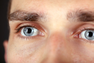 Fototapeta premium Beautiful blue man eyes close up