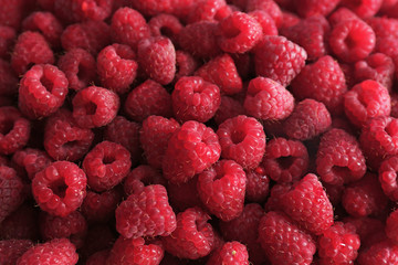 Heap of sweet red raspberries close up