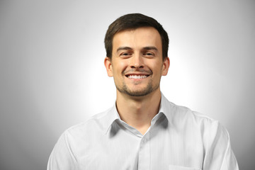 Handsome young man on gray background