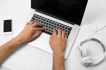 Fototapeta premium Man hand on laptop on table top view