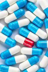 blue capsules and red capsules, medication cure close up