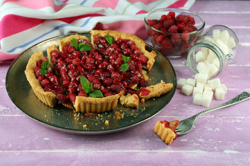 Piece of tart with raspberries on tray, close-up