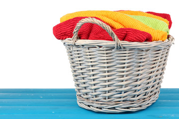 Obraz premium Colorful towels in basket on light background