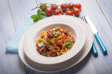 tagliolini with squid and fresh tomatoes