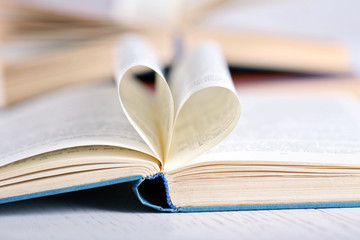 Pages of book curved into heart shape, close up