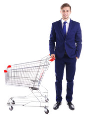 Young man with empty shopping cart, isolated on white