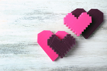 Plastic hearts on wooden background