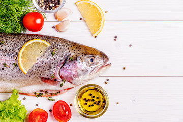 Raw trout with spices on a light  background
