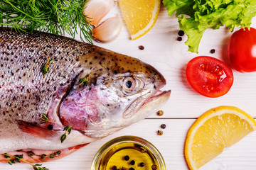 Raw trout with spices on a light  background