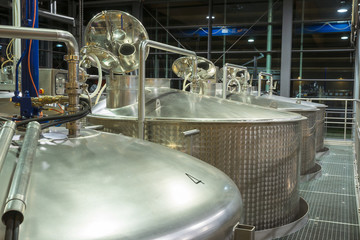 Contemporary large steel barrels in winery, food industry 