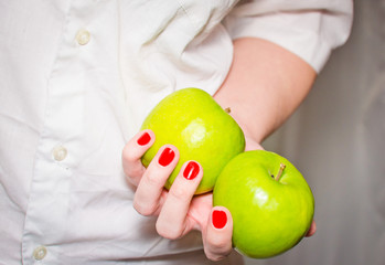 Two green apples in female hands