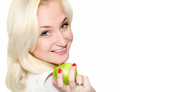 Blond woman eat green apple.Place for text for your design.