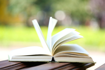 Stack of books outdoors, on blurred background