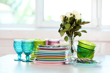 Fototapeta na wymiar Clean plates, glasses and cutlery on white table