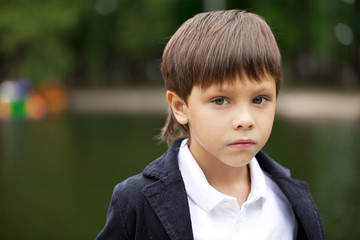 Fashionable little boy outdoor at the nice summer day