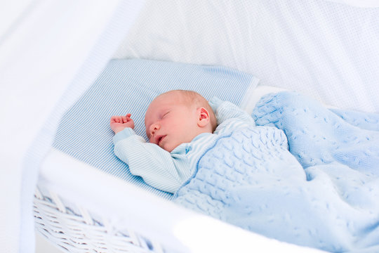 Newborn Baby Boy In White Bassinet