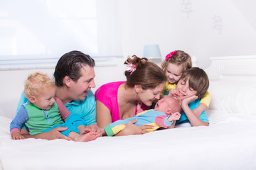 Big family with kids in bed