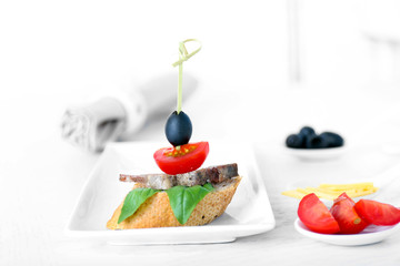 Tasty canapes on wooden table, close up