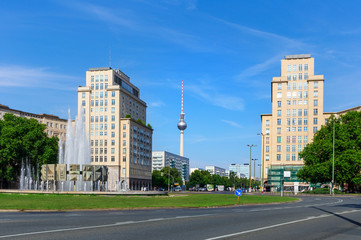 Fototapeta na wymiar Karl-Marx-Allee in the Friedrichshain district with a view to the TV tower at Alexanderplatz, Berlin