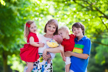 Portrait of happy woman with four kids