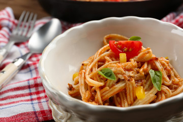 Homemade Spaghetti Bolognese with parmesan cheese in white bowl, on color wooden background