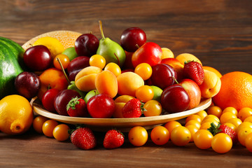 Assorted of fresh fruits on wooden background