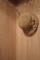 a straw hat hanging in the hallway