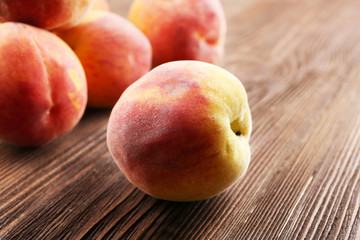 Fresh peaches on wooden table, closeup