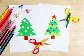 Creative paper Christmas tree on white paper sheet, scissors and colorful crayons on color table...