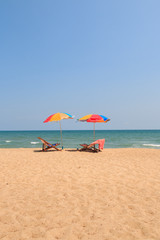 Beach chair and umbrella on sand beach