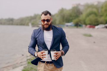 Fototapeta premium bearded man carrying coffee