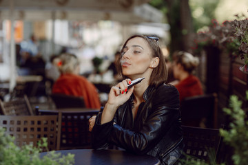beautiful glamorous brunette smoke electronic cigarette