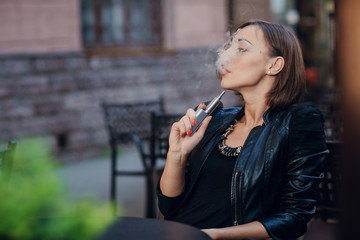 beautiful glamorous brunette smoke electronic cigarette