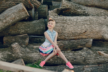 beautiful little girl sitting on trees