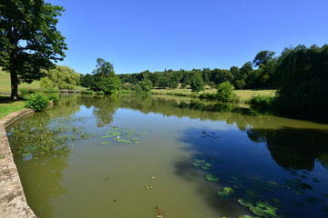 An English country estate with a pond on a hot summers day in August.