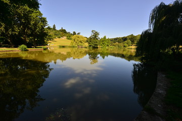 An English country estate with a pond on a hot summers day in August.