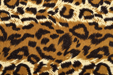 Brown leopard fur pattern. Spotted animal print as background.
