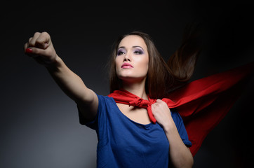 Superwoman. Young pretty woman opening her shirt like a superher