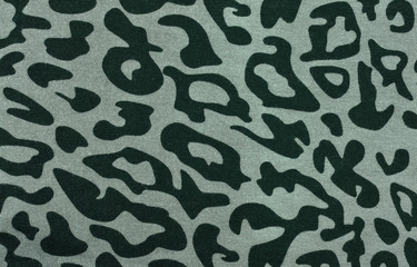 Green and black leopard fur pattern. Spotted animal print as background.