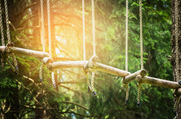 rope bridge in climbing forest or high wire park