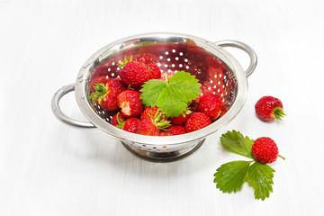 Ripe strawberries in a colander