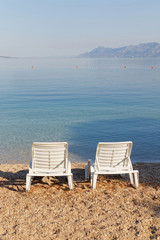 Two empty deck chair on the beach