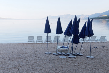 Lots of empty deck chair and many parasol