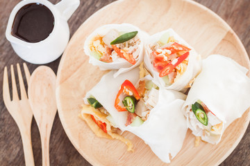 Fresh spring rolls on wooden table