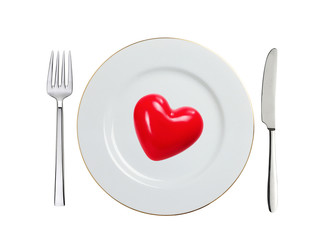 Fototapeta na wymiar red heart on white plate, spoon and fork isolated on white