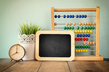 blackboard, stack of colorful beaded abacus and clock