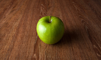 fresh green apple on a wooden table